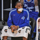 A masked LeBron James on the Lakers bench.